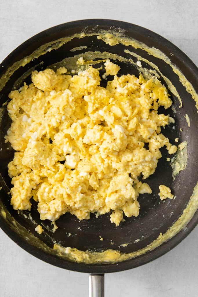 Scrambled eggs in a frying pan.