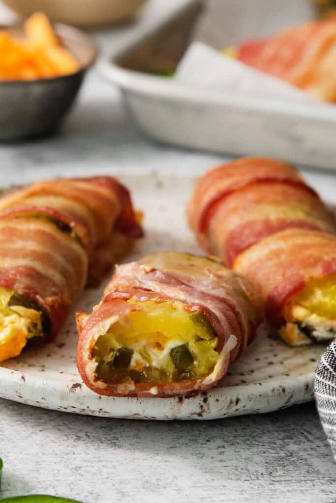 Bacon wrapped eggs on a plate.