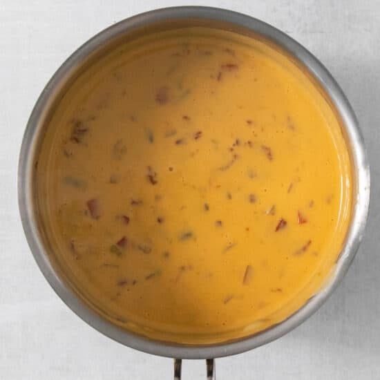A pan full of soup on a white background.