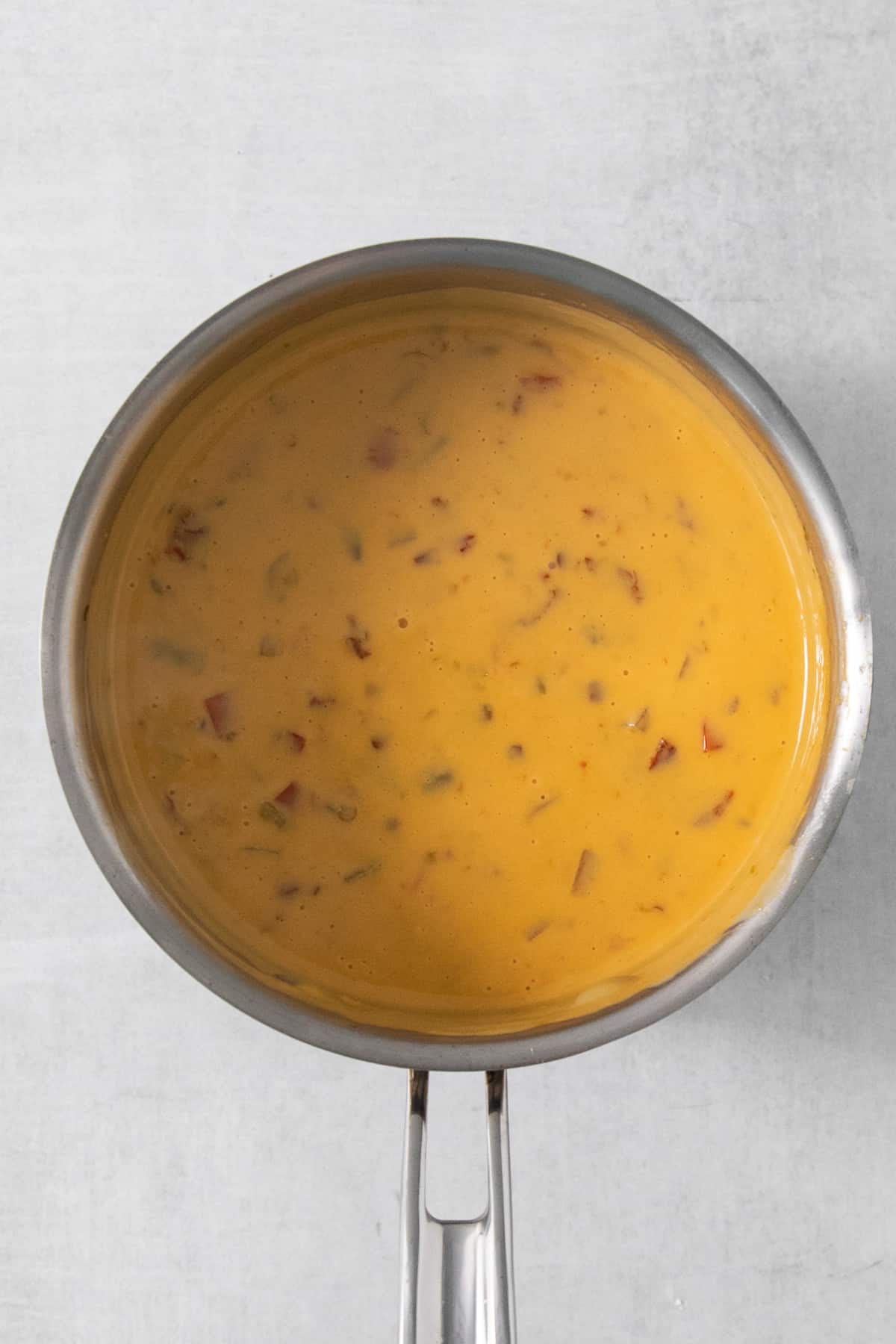 A pan full of soup on a white background.