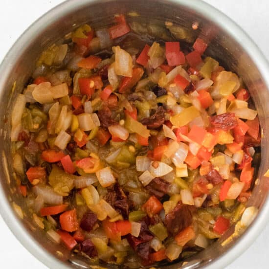 A stainless steel bowl filled with chopped vegetables.