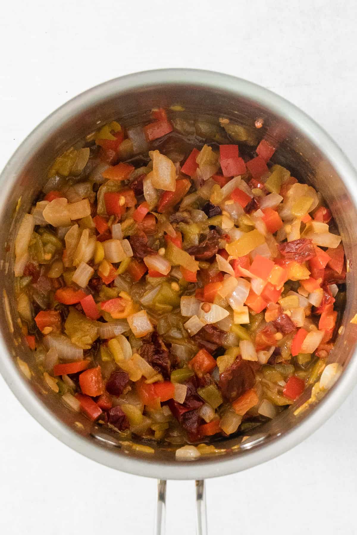 A stainless steel bowl filled with chopped vegetables.