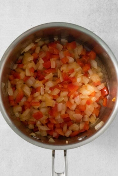 Chopped onions in a pan on a white background.