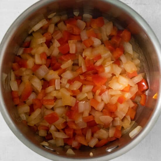 Chopped onions in a pan on a white background.