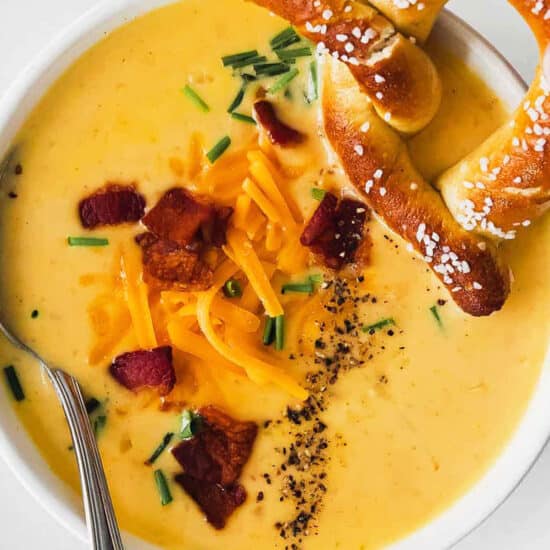 A beer cheese soup with pretzels and bacon.