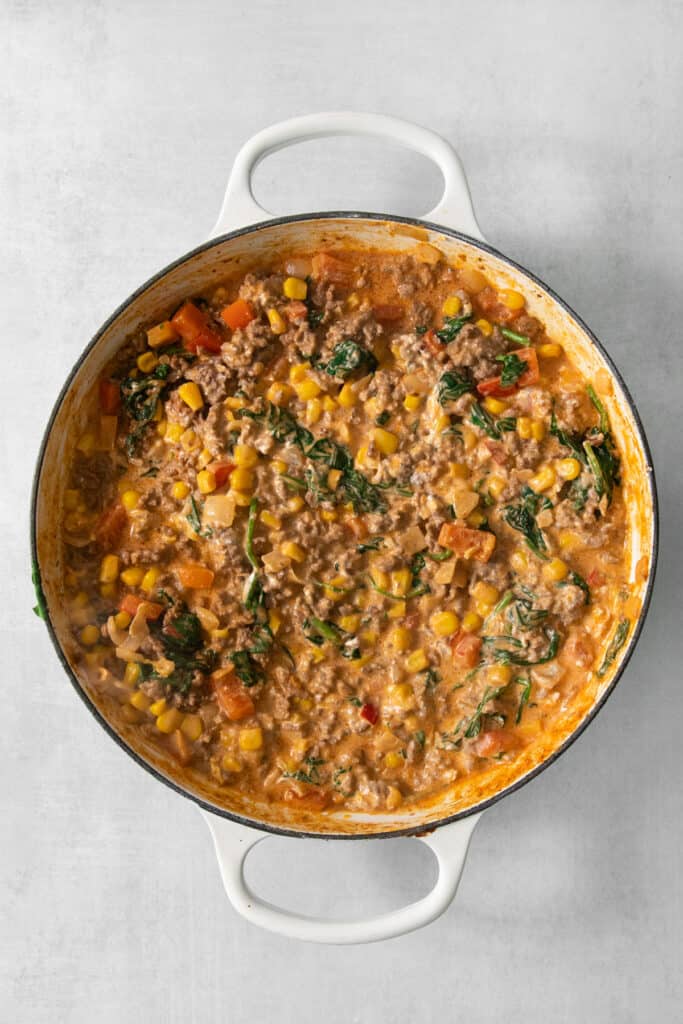 A cowboy casserole with meat and vegetables in it.