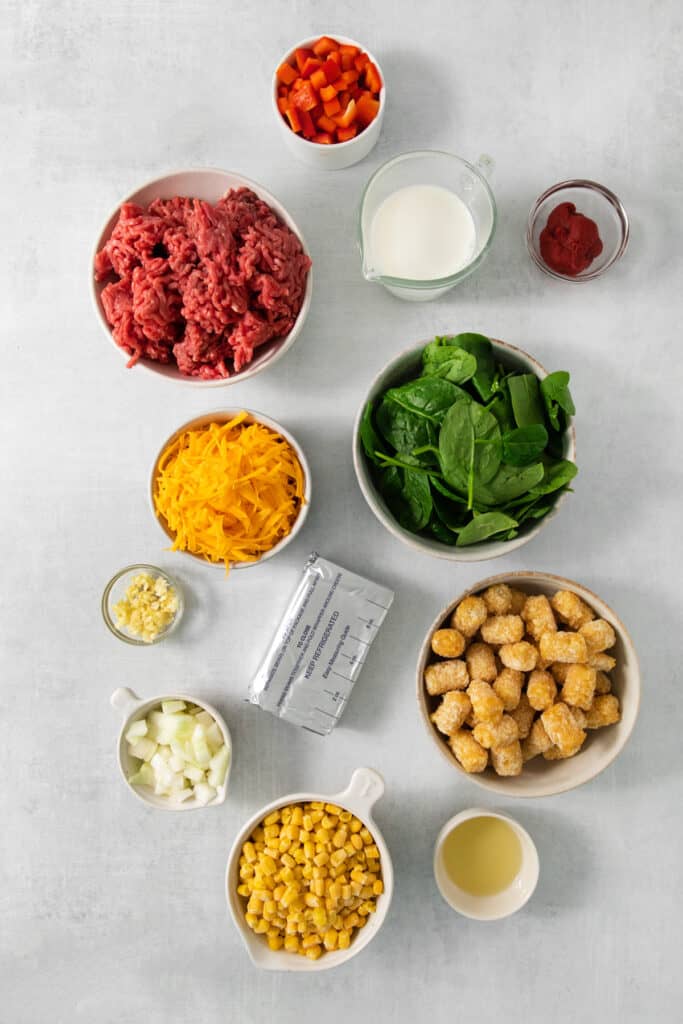 The ingredients for a recipe for cheesy cowboy casserole, featuring tater tots.