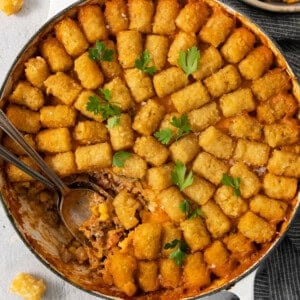 Cowboy casserole in a pan with a spoon.