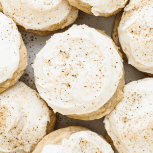 A plate of cookies with icing and cinnamon.