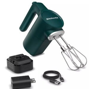 A green kitchenaid mixer with a charger and other accessories.