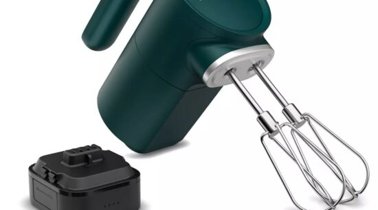 A green kitchenaid mixer with a charger and other accessories.