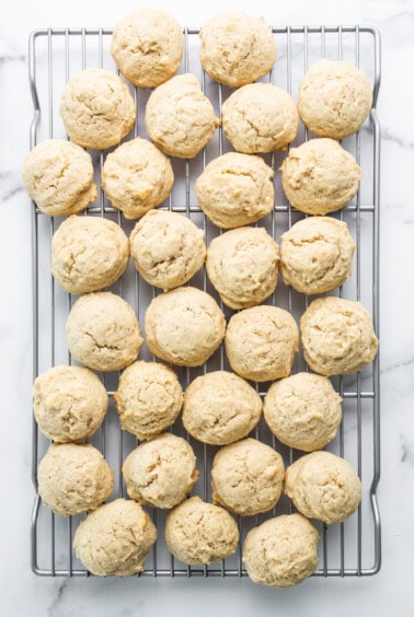 Cookies on a cooling rack on a marble countertop.