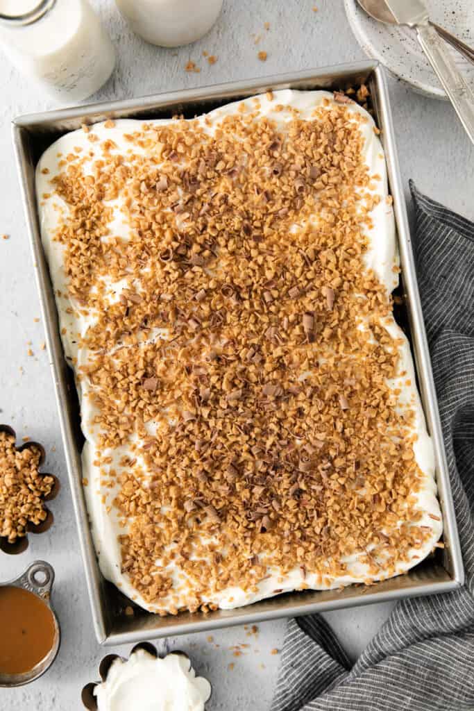 A pan of ice cream with a layer of granola on top.