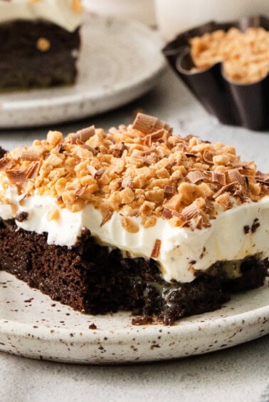 A piece of chocolate cake on a plate with a fork.