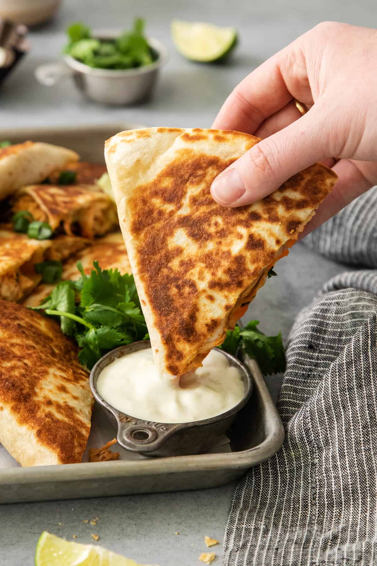 Quesadillas on a tray with dipping sauce.