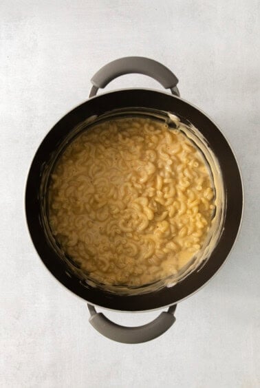 Macaroni and cheese in a pan on a white background.