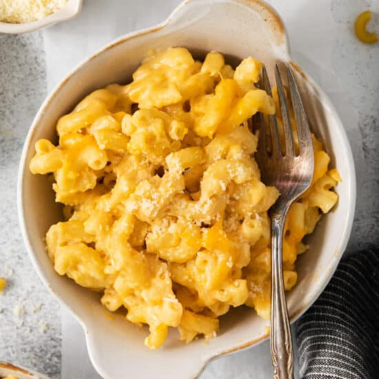 Macaroni and cheese in a bowl with a fork.