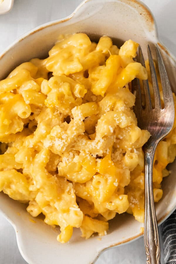 Macaroni and cheese in a bowl with a fork.