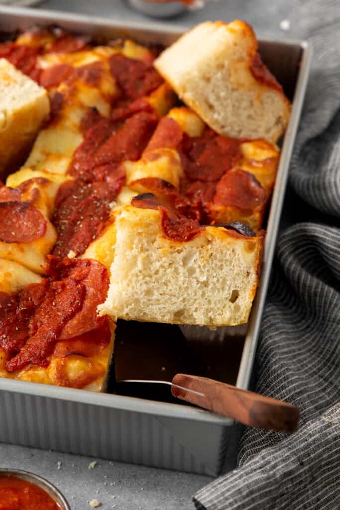 A pan of pepperoni pizza on a table.