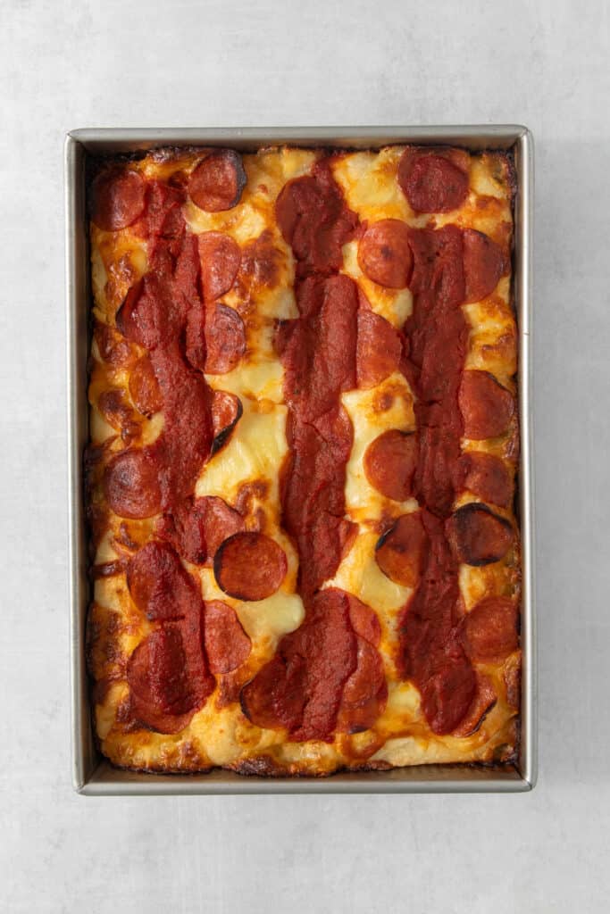 Pepperoni pizza in a metal pan.