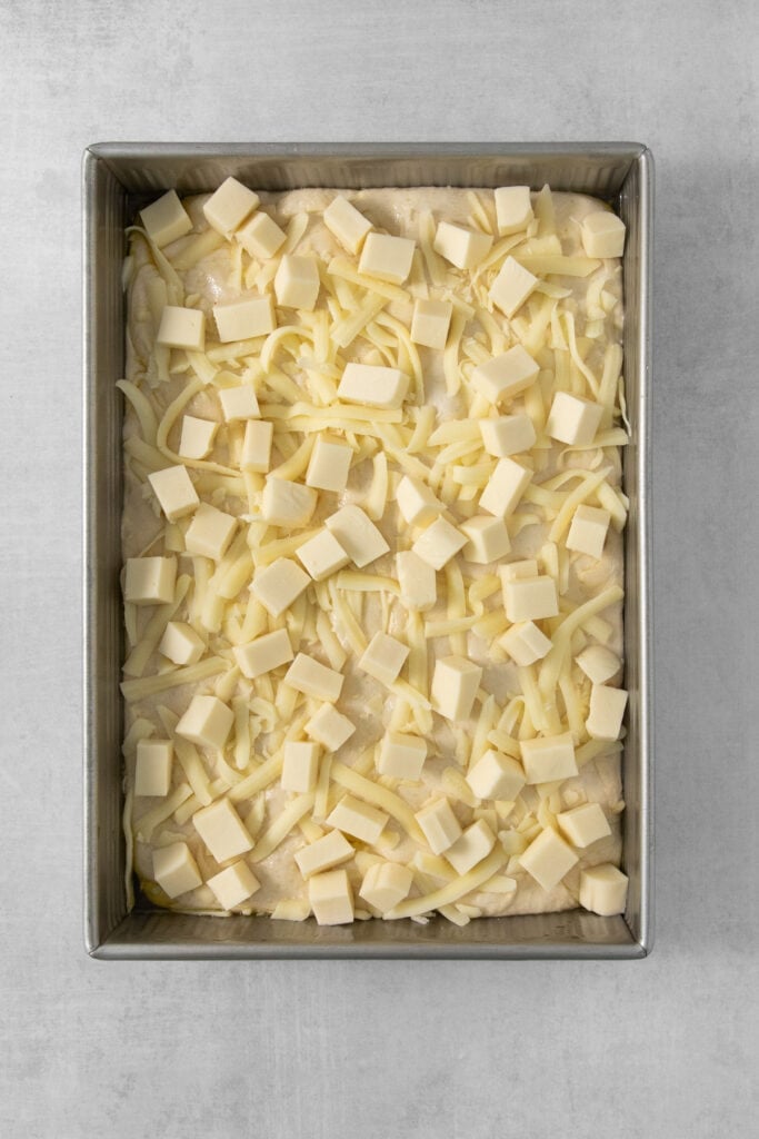 A baking pan filled with cheese cubes.