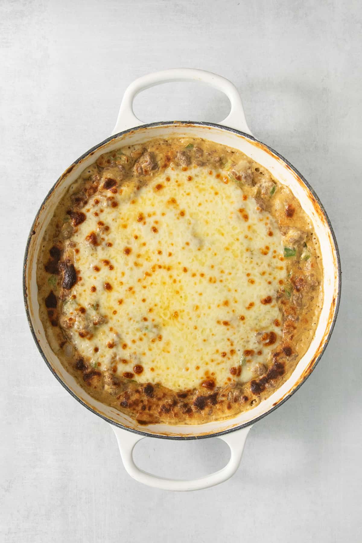 A casserole dish with cheese and meat in it.