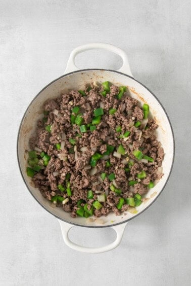 Ground beef in a pan on a white background.