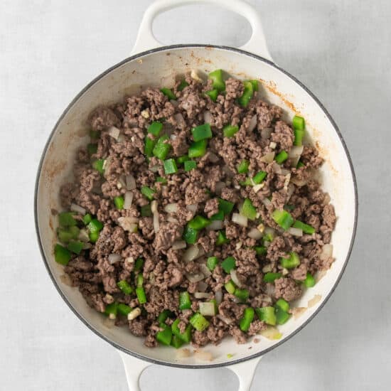 Ground beef in a pan on a white background.