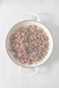Ground beef in a skillet on a white background.