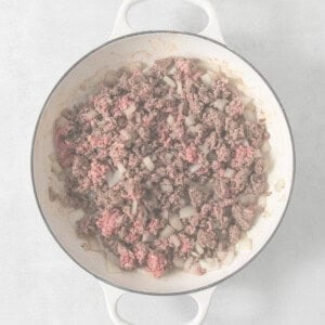 Ground beef in a skillet on a white background.