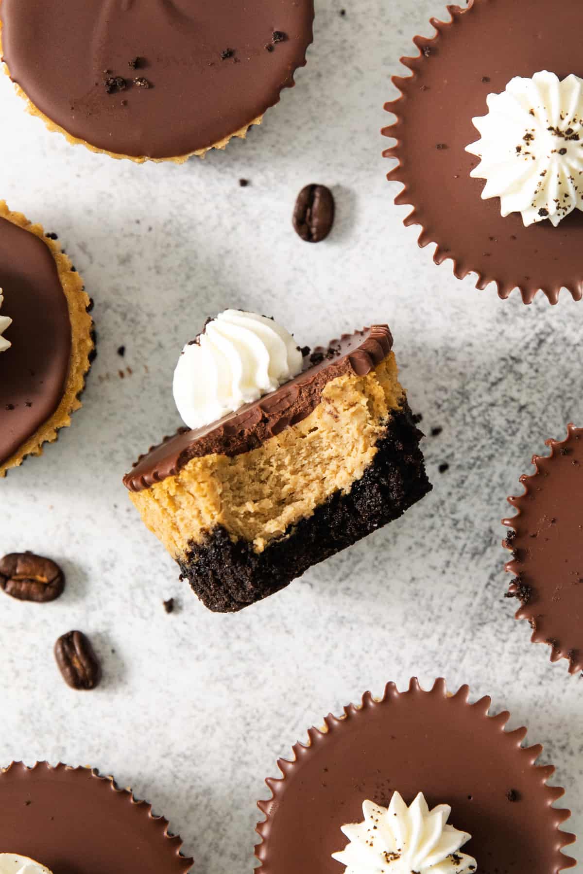 A group of chocolate and peanut butter pies on a white surface.