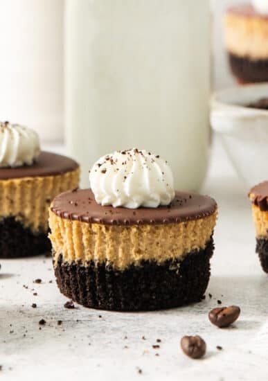 A group of chocolate peanut butter cheesecakes on a white table.