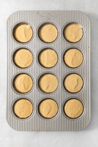 A muffin tin with cupcakes in it.