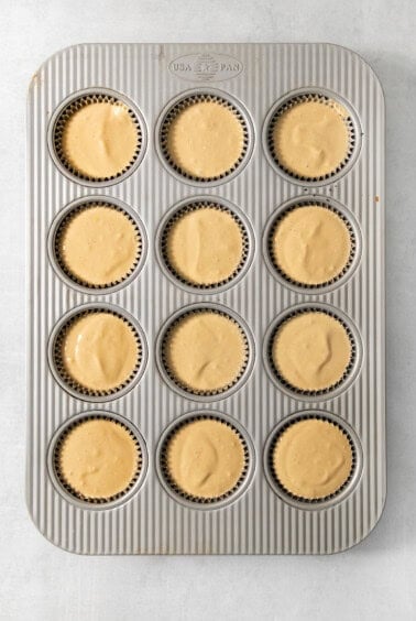 A muffin tin with cupcakes in it.