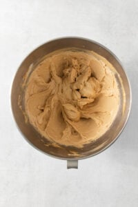 Peanut butter in a bowl on a white surface.