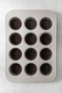 A muffin tin filled with chocolate cupcakes.