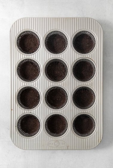 A muffin tin filled with chocolate cupcakes.