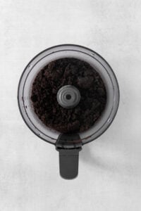 A coffee grinder with a cup of coffee in it.