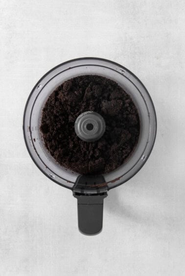 A coffee grinder with a cup of coffee in it.