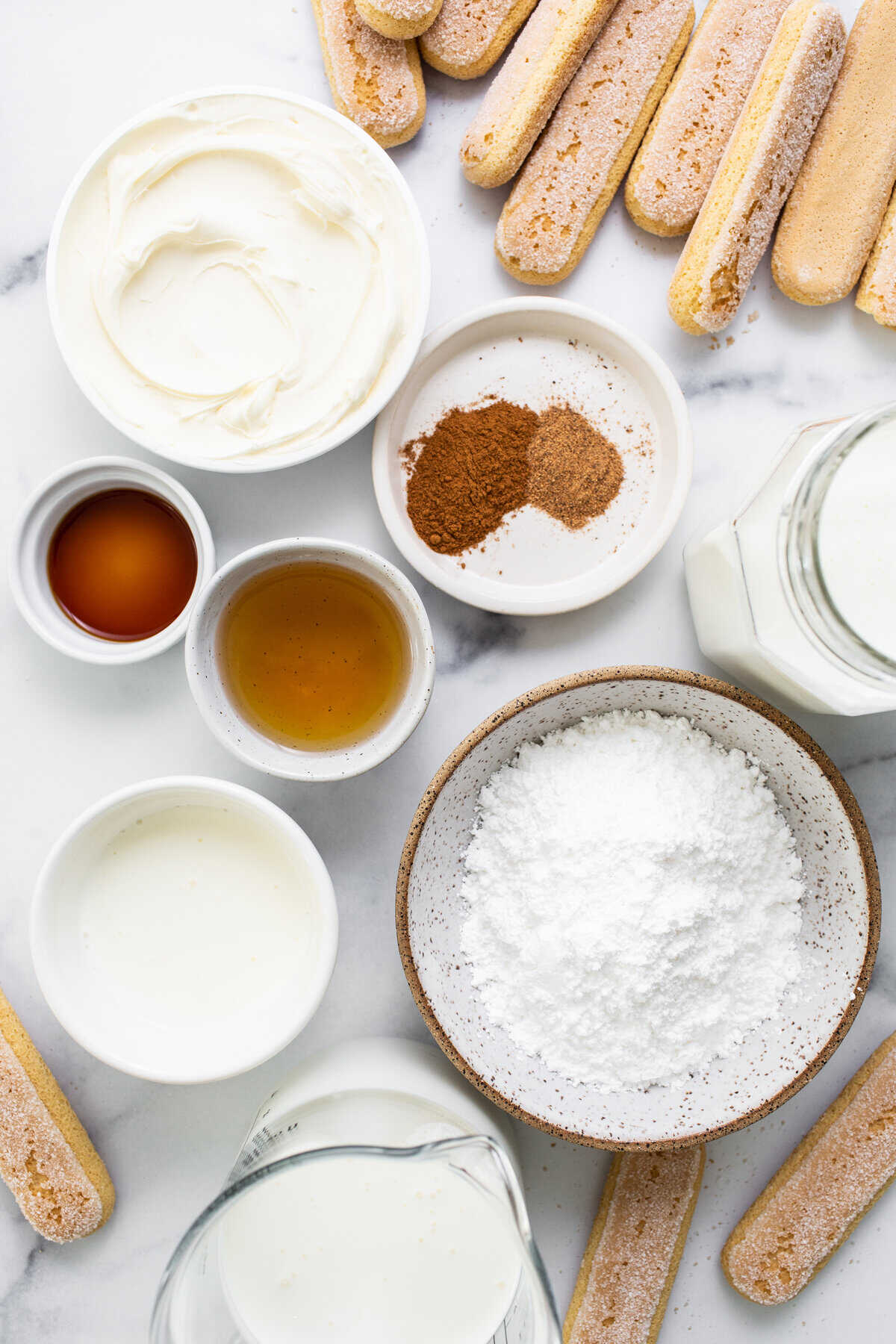 A table with various ingredients on a marble surface.