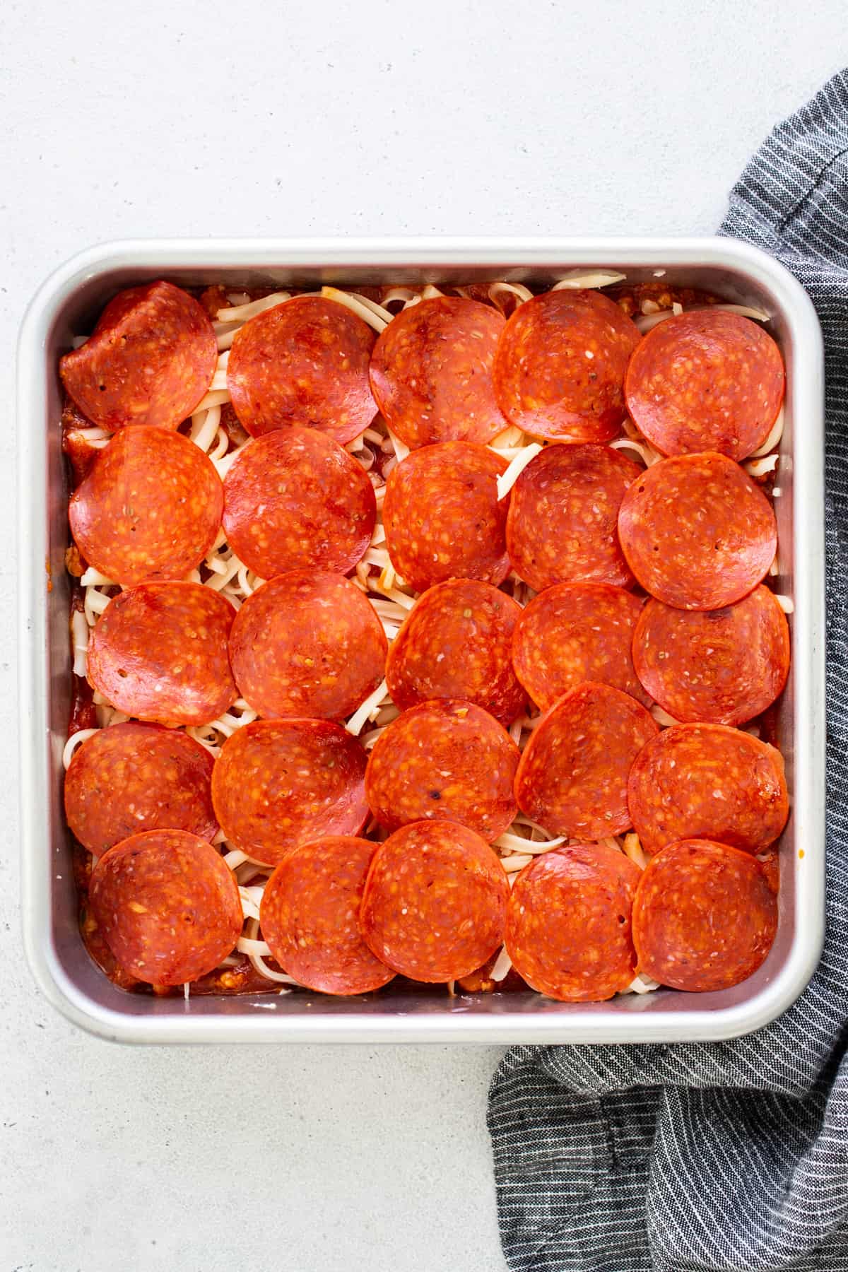 Pepperoni pizza in a baking dish.