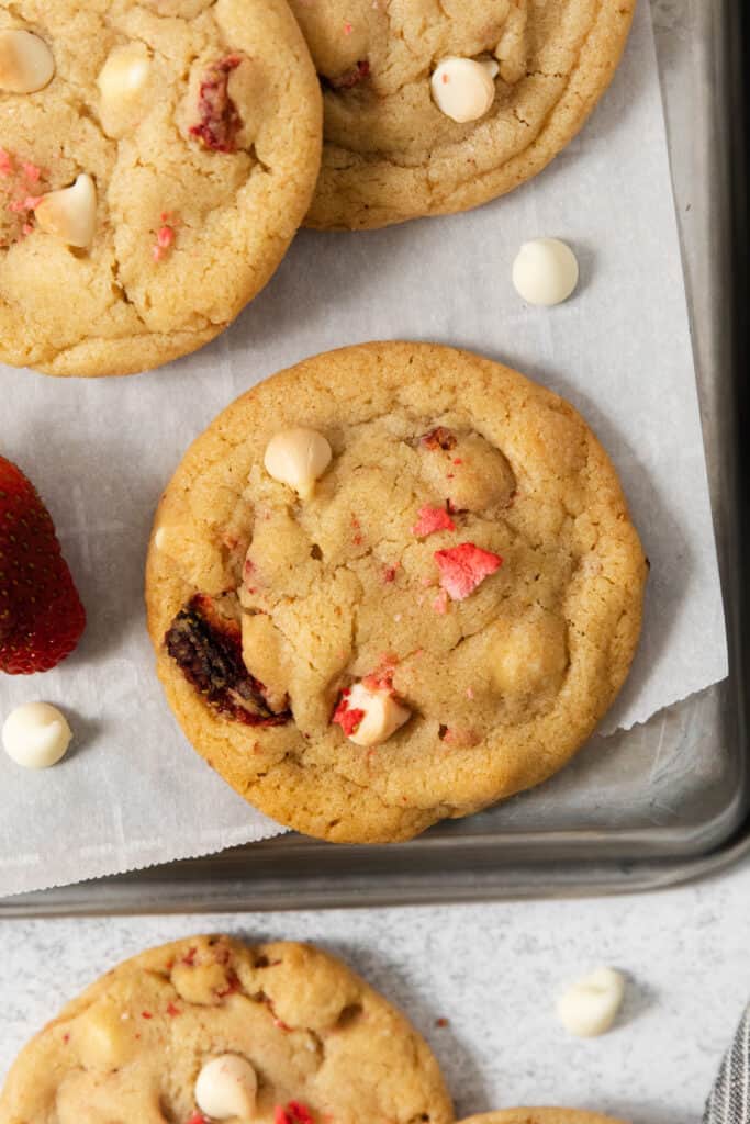 Strawberry white chocolate chip cookies on a baking sheet.