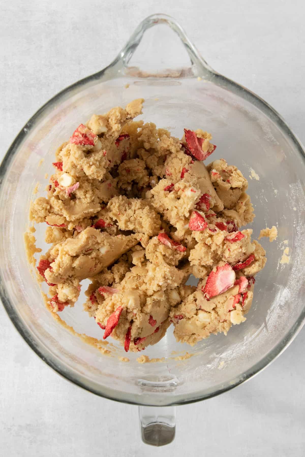 Strawberry cookie dough in a glass bowl.