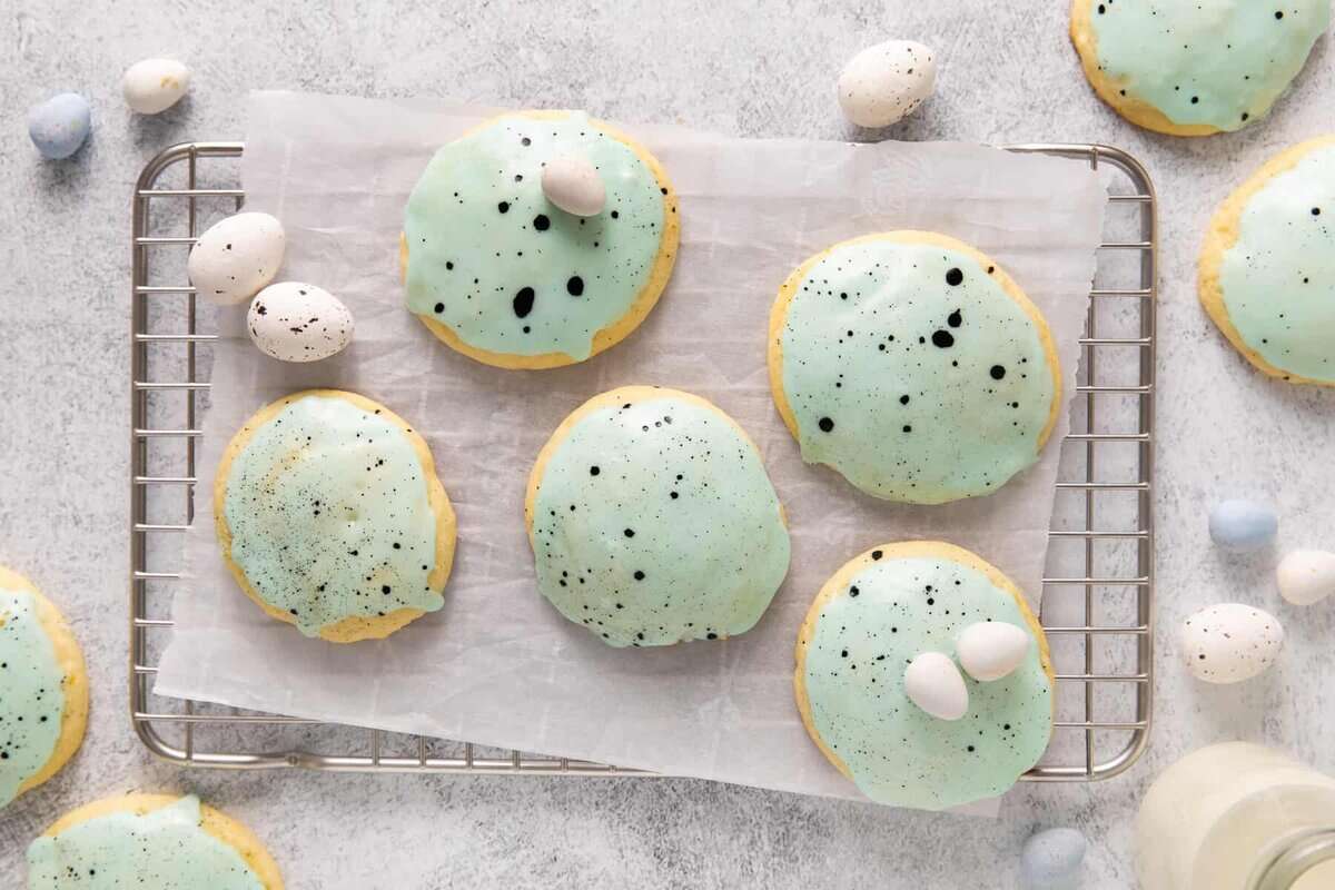 These lemon ricotta easter egg cookies are the perfect sweet treat to celebrate spring. They have a bright, lemony flavor and creamy, airy texture that you can only get with a lemon ricotta cookie. Lemon ricotta cookies on a cookie sheet.