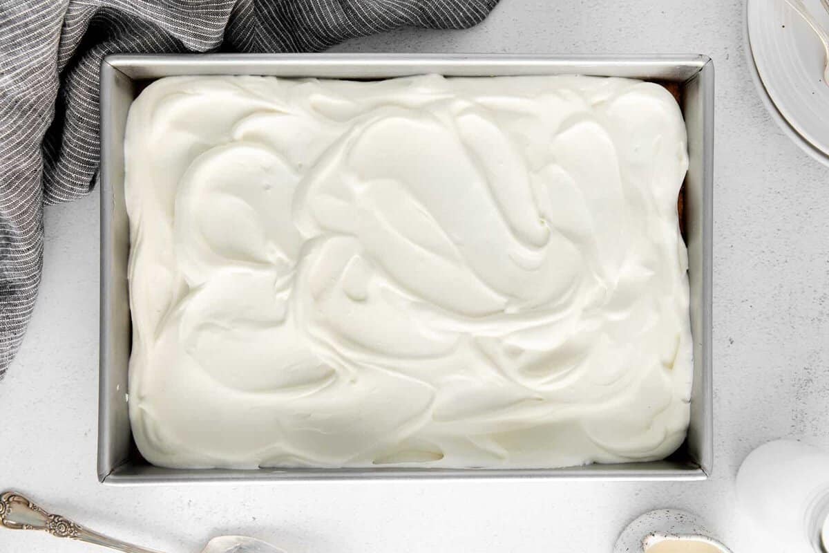 frosted cake in cake pan.