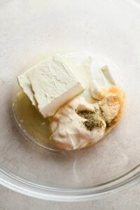 Cream cheese dressing ingredients in a glass mixing bowl