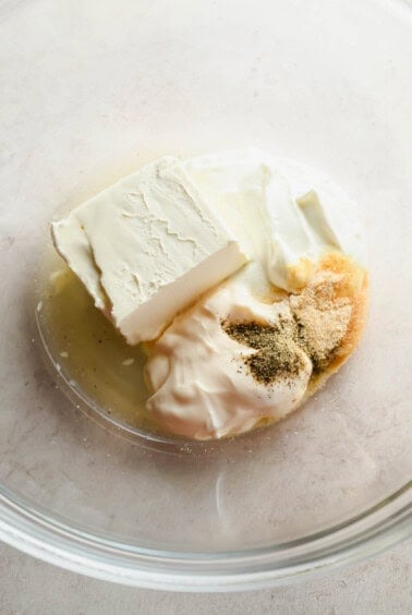 Cream cheese dressing ingredients in a glass mixing bowl