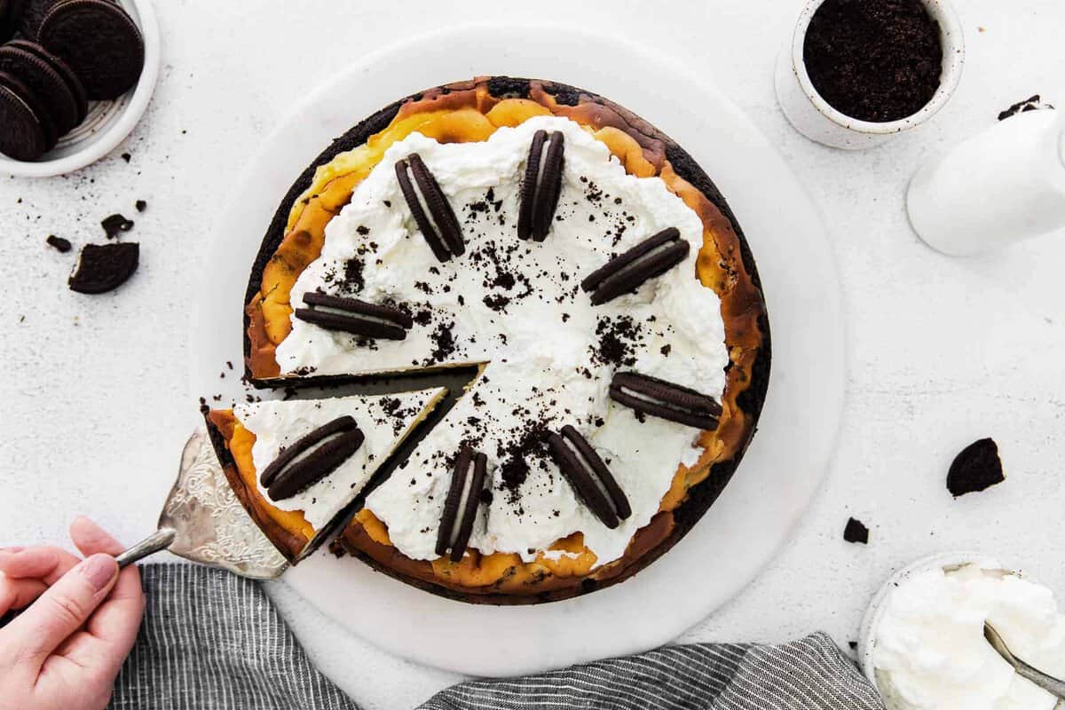 oreo cheesecake topped with whipped cream and oreos