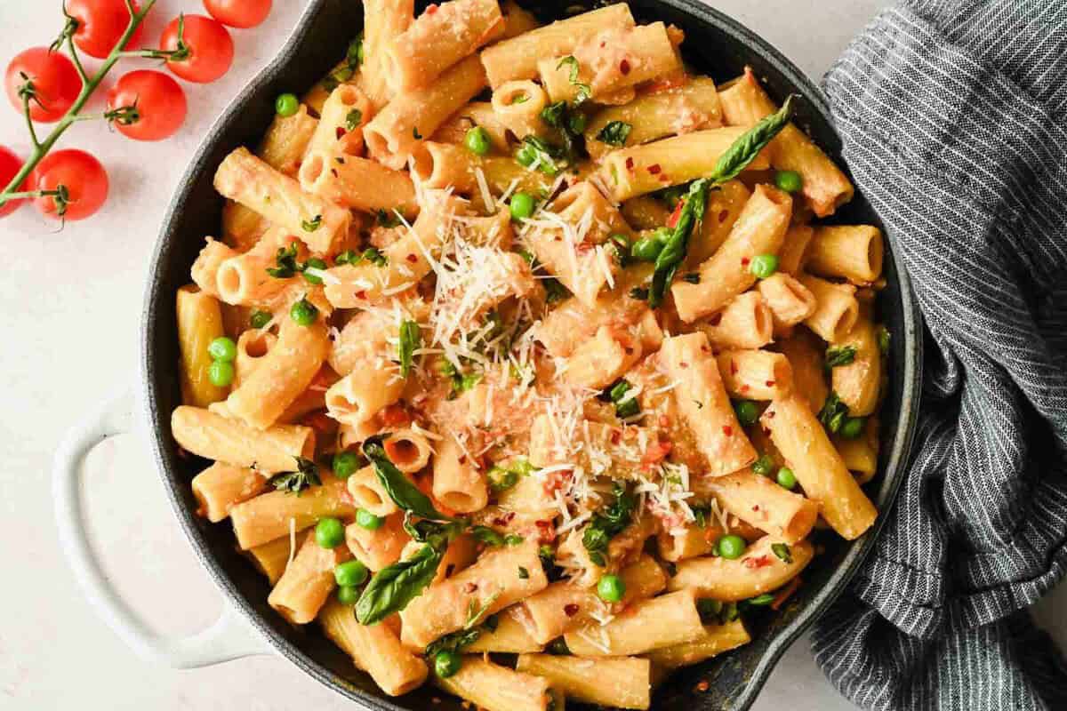 Spicy cottage cheese pasta with rigatoni, peas, Parmesan, and fresh basil