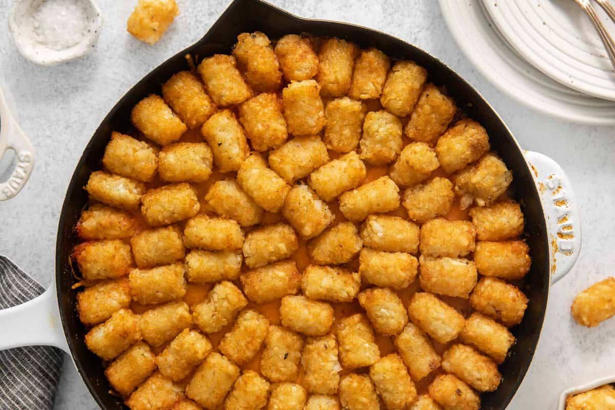 a skillet filled with tater tots.